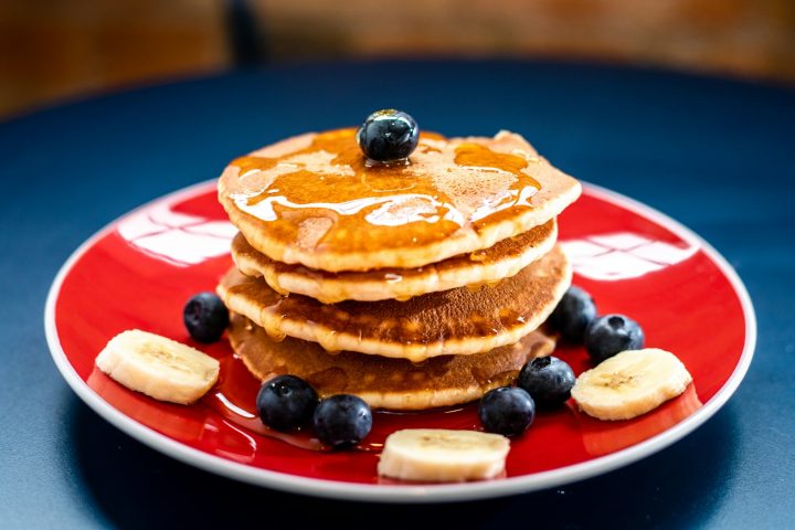 Pancakes topped with blueberries and banana slices