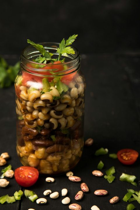 Three bean salsa salad packed in a clear glass jar