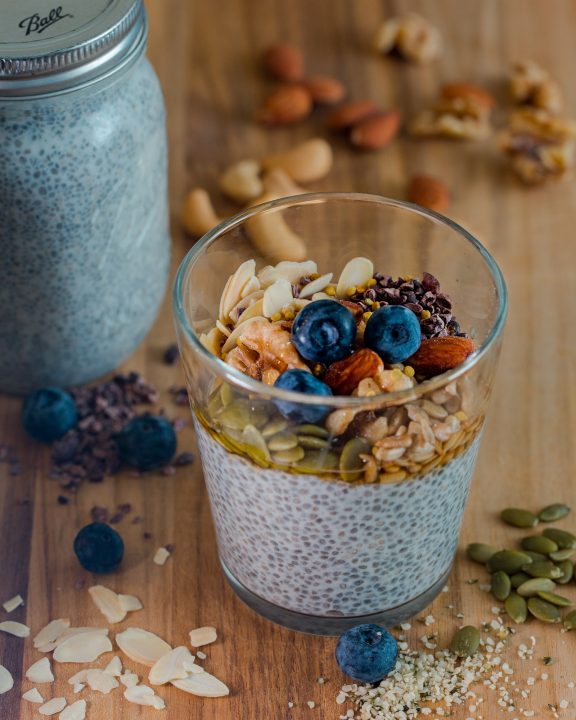 Chia pudding with seeds in a clear drinking glass