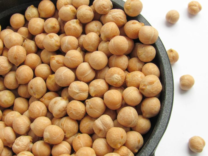 A bowl filled with chickpeas sitting on top of a table