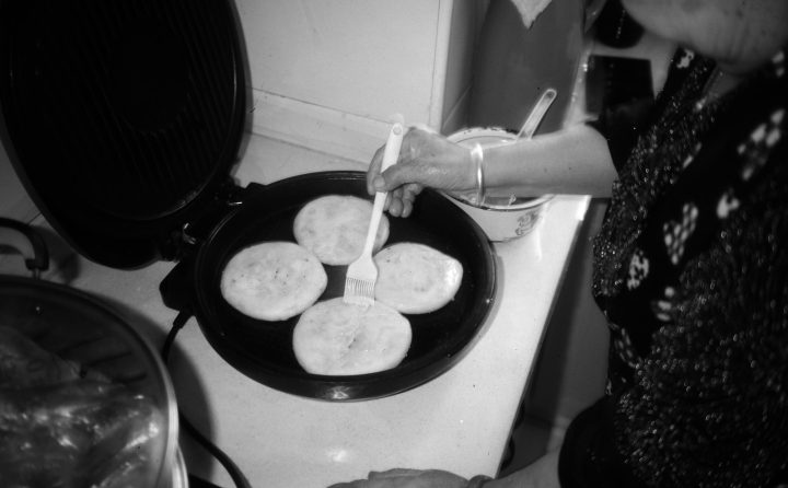 Person cooking pancakes on a griddle