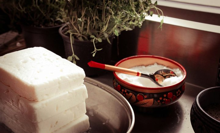 Cottage cheese in a red ceramic bowl with a gray spoon