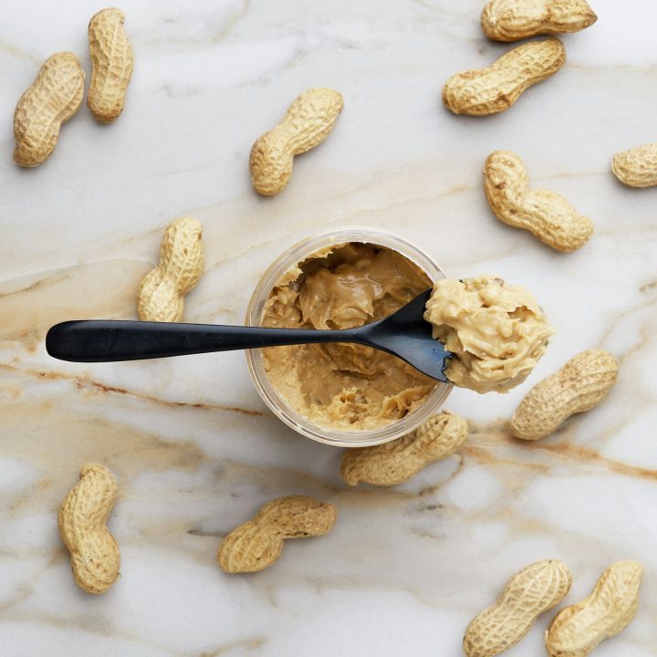 Creamy peanut butter with a black spoon