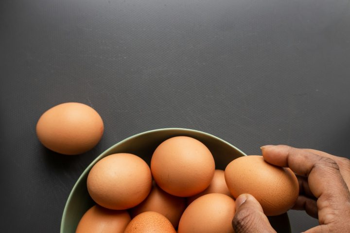 Brown eggs in a stainless steel bowl, ready for an egg bake