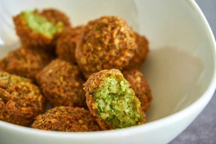 Golden falafel balls in a white ceramic bowl