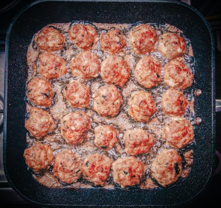 A pan filled with meatballs covered in tomato sauce