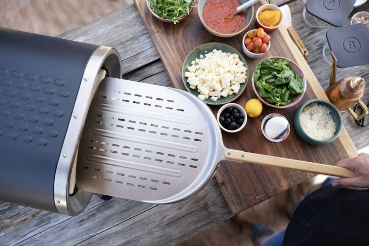 A person grating cheese with a grater on a cutting board