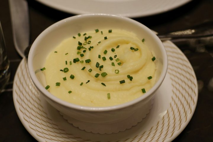 A bowl of mashed potatoes topped with chives