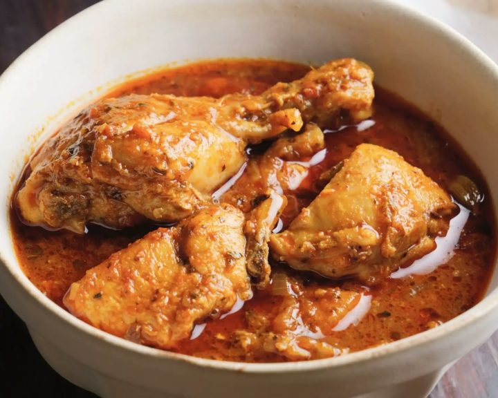 Chicken curry in a white bowl with sauce