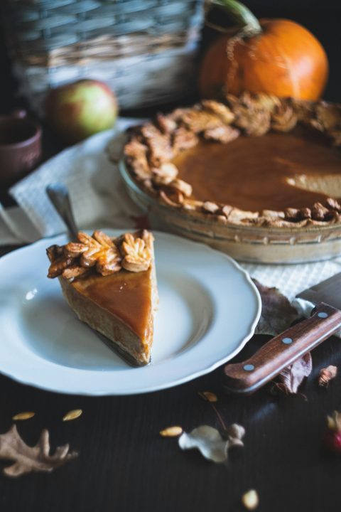 A slice of pumpkin pie on a plate