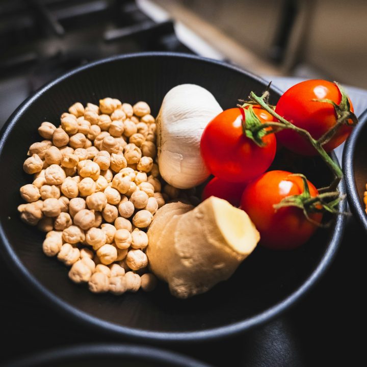 Chickpeas, garlic, ginger, and tomatoes in a bowl