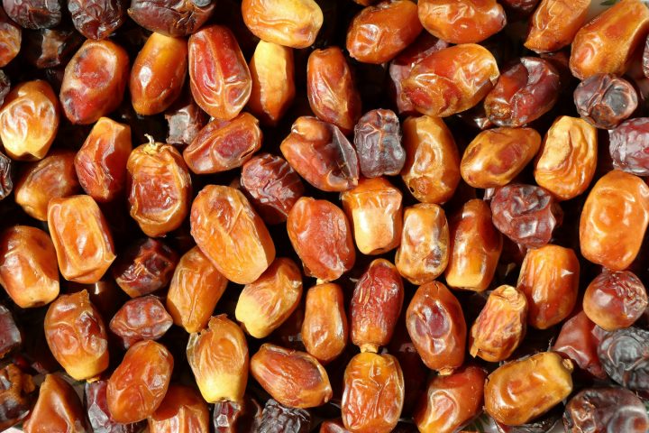 A pile of soft, wrinkled Medjool dates