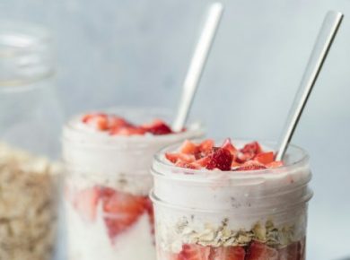 Oats topped with cream and sliced strawberries