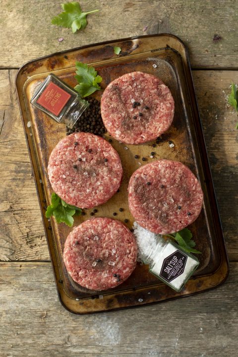 Raw meat on a brown wooden chopping board
