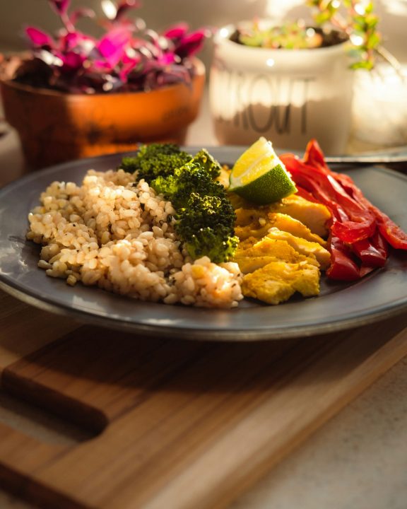 Cooked rice with broccoli and carrots on a plate