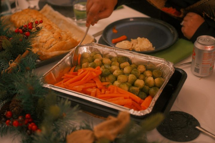 Roast vegetables including carrots and Brussels sprouts on a table
