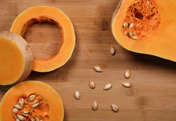 Sliced pumpkin on a brown wooden surface