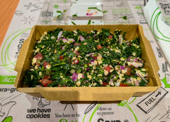 Tabbouleh with parsley, tomatoes and onions packed in a cardboard container