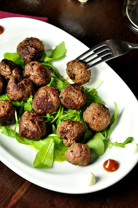 Meatballs on an oval white plate